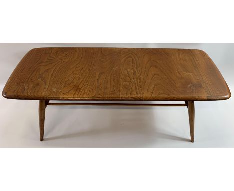 A mid 20th century Ercol beech and elm rectangular coffee table with stick under tier, on four tapering legs, purchased in ap