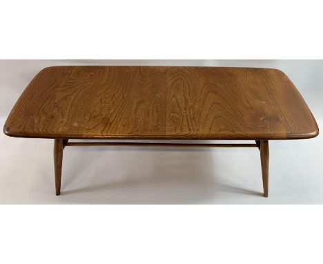 A mid 20th century Ercol beech and elm rectangular coffee table with stick under tier, on four tapering legs, purchased in ap