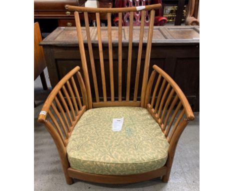 An Ercol 'Renaissance' low armchair, with base upholstered in green fabric but lacking cushions, 78cm wide (max)