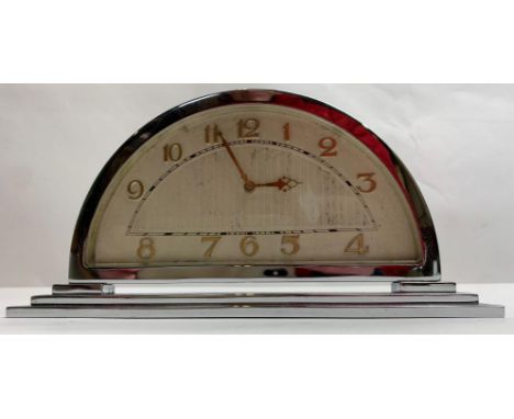 An Art Deco chrome half moon mantel clock