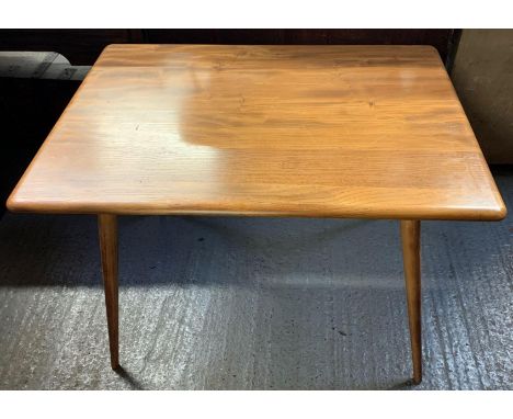 A mid 20th century Ercol beech and elm rectangular breakfast table, with slatted under tier to the top and on four tapering l