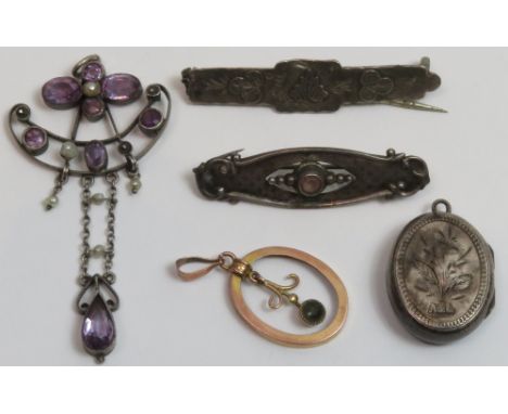 An Edwardian amethyst and seed pearl pendant; two brooches; a locket pendant and a paste set pendant