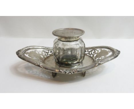 An Edwardian silver standish, by Goldsmiths and Silversmiths Co Ltd, London 1903, the oval facetted clear glass well with a s