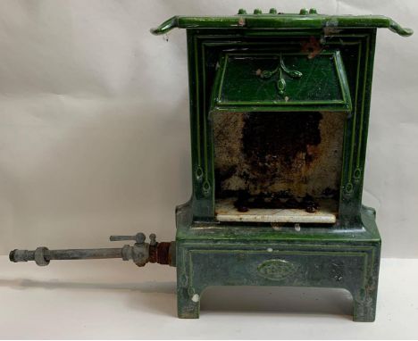 A German cast iron and green enamel mantle heater in the form of a fireplace, late 19th/early 20th century, by Welsbach Kern,