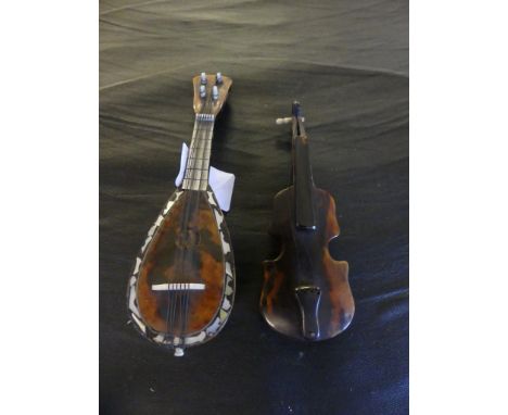 A miniature tortoiseshell and mother of pearl decorated mandolin together with a further tortoiseshell violin (2) 
