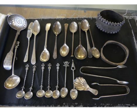 A mixed lot of various silver and white metal wares to include a range of various tea and coffee spoons, large bangle, siftin