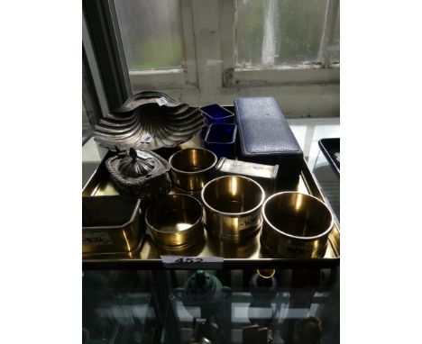 A mixed lot of various silver items to include a shell formed butter dish, cruet items, napkin rings, a cased collectors spoo