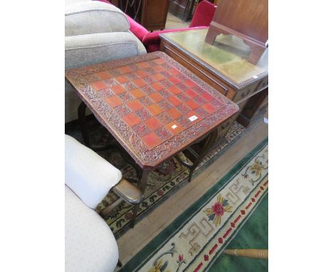 An early 20th Century mahogany occasional table with under tier and a carved chess board 