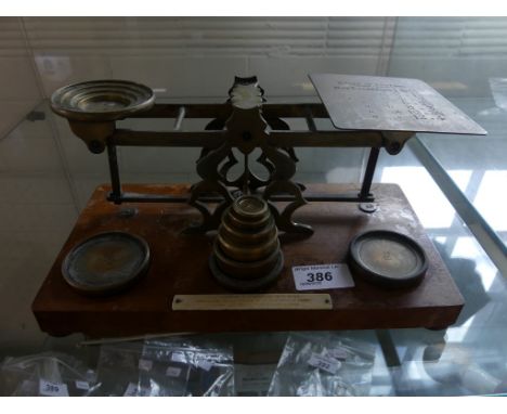 A vintage brass postal balance scales with accompanying weights 