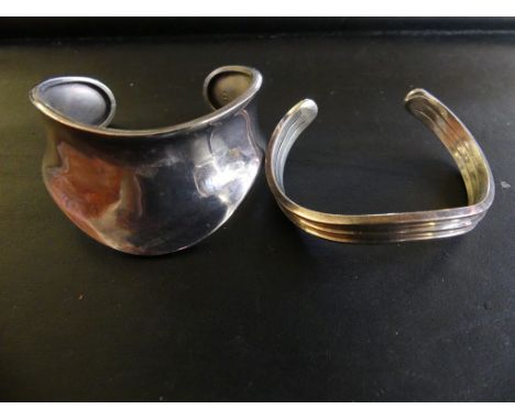 A silver cuff bangle with one further bangle, stamped 'sterling', weight approx 59.3g. 