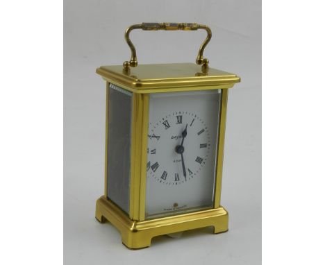 A 20th century French carriage timepiece, with a cornich case and white enamel dial set out with Roman numerals, H. 12cm.