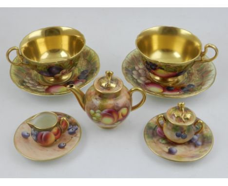 A pair of Ansley cabinet cups, decorated fruit on a mossy bank, together with Royal Worcester miniature tea service, (qty).