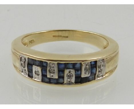 A 9 carat yellow gold, diamond, and sapphire half eternity ring, the stones set in a Greek key pattern. 