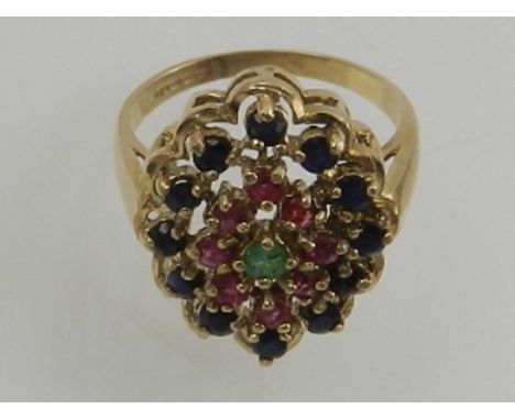 A 9 carat yellow gold, sapphire, ruby, and emerald cluster cocktail ring. 