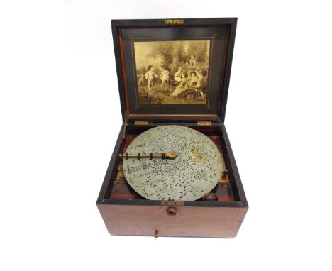 A LATE 19TH CENTURY POLYPHON DISC MUSIC BOX serial number 91186, with a gilded metal bed, the lid with a pictorial papered in