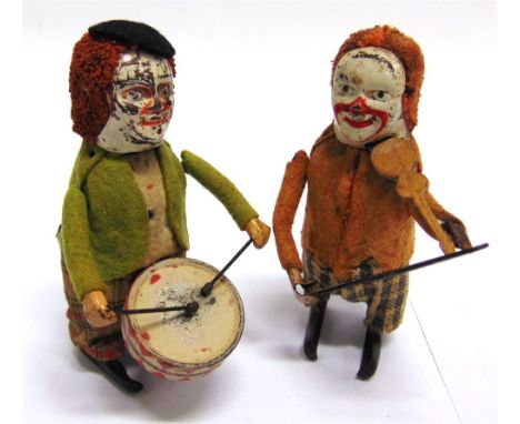 TWO SCHUCO CLOWN MUSICIANS the first playing a violin, and the second playing a drum, both with clockwork mechanisms (working