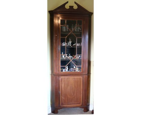 A 19th Century mahogany Corner Cabinet, with pediment, astragal glazed doors, on a frieze with inlaid panel door, with bracke
