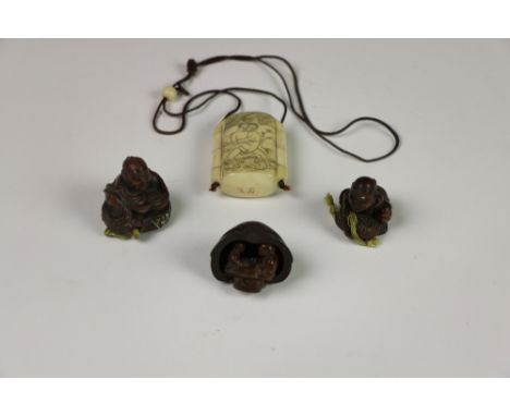 A four compartment Chinese etched bone Inro, with erotic scene, two Chinese carved wooden Netsukes and another item. (4)