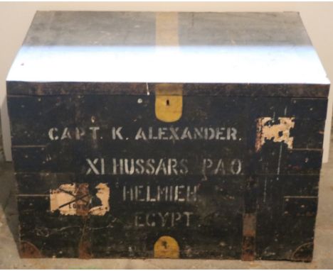 An antique large tin bound wooden Military Trunk, inscribed 'Capt. K. Alexander, XI Hussars P.A.O. Helmieh, Egypt.' (1)