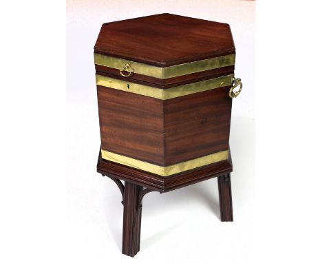 An attractive Georgian period octagonal Cellaret, with plain brass mounts and heavy shaped drop handles on tripod stand with 