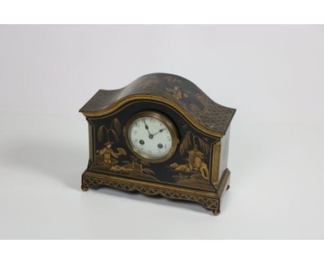 A chinoiserie decorated gilt and black lacquered Mantle Clock, with French movement and enamel dial with Arabic numeral on br