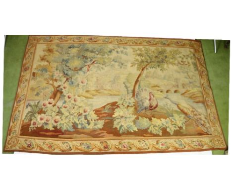 A fine Aubusson Verdure polychrome Tapestry, 19th Century, depicting a turkey and a peacock under foliage, by a river with ca