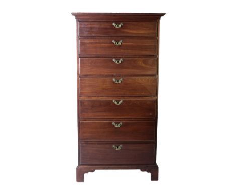 An Irish Georgian period mahogany Tallboy, the hooded and moulded cornice over seven graduating drawers with decorative brass