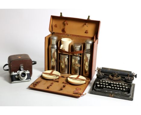 A Picnic Case, furnished with tea service etc., two portable Typewriters, two old Cameras, Record Holder, etc. As a lot. (1)
