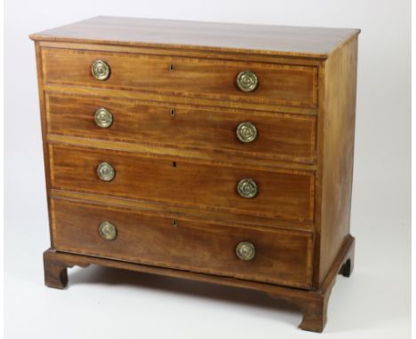 A Georgian period mahogany Chest, the top with large oval inlaid decoration and similar crossbanding over four long drawers w