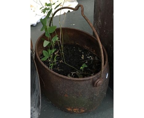 An iron garden planter, with loop handle 