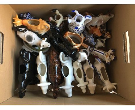 A large collection of English and continental ceramic cow creamers, including Guernsey, Jersey, Majolica, Delft, Royal Crownf