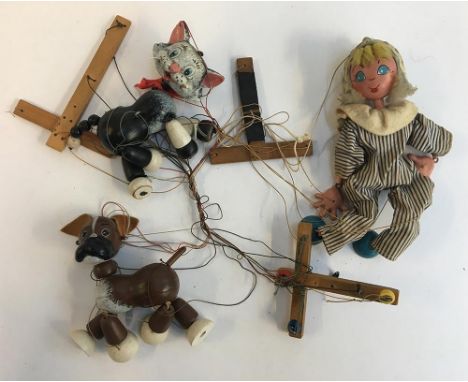 A Pelham Puppet black and white cat, with plastic body and wooden limbs; together with a Pelham Puppet dog, with plastic body