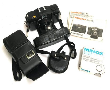 A Minox 35 GT in carry case, with accessories to include instruction manuals and flash unit 