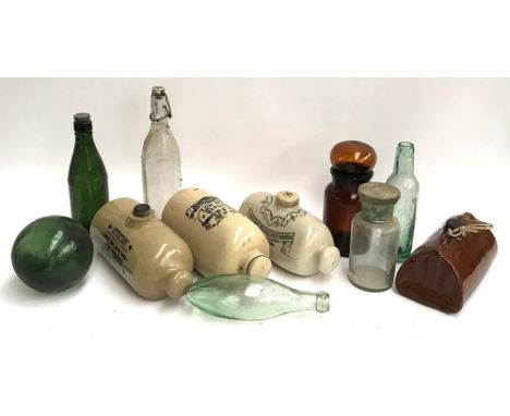 A mixed lot to include four stoneware hot water bottles, chemist's jars, and several vintage glass bottles to include William