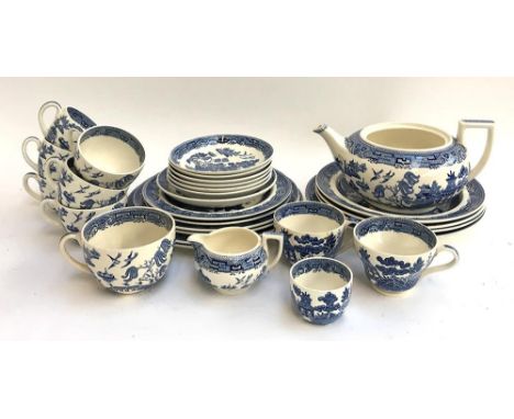 A Wedgwood willow pattern teaset to include six cups and saucers, various plates, milk jug and sugar bowl, an early teacup, e