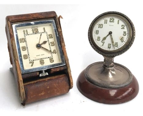 A Jaeger LeCoultre 8 day alarm clock, chrome and leather; together with an 8 day alarm clock on swivel stand and marble base 
