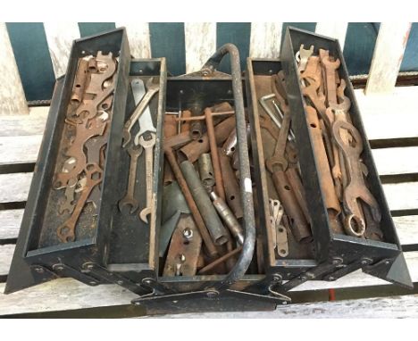 A metal toolbox containing various spanners and associated items 
