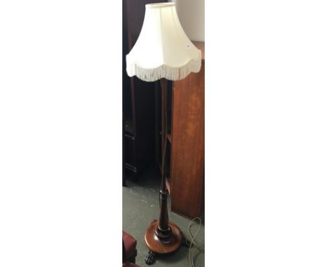 An attractive standard lamp with turned base on paw feet, 150cmH 
