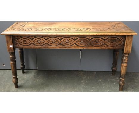 An oak side stool with demilune carved top, 96cmW; together with a very narrow hanging shelf, 188cmL 