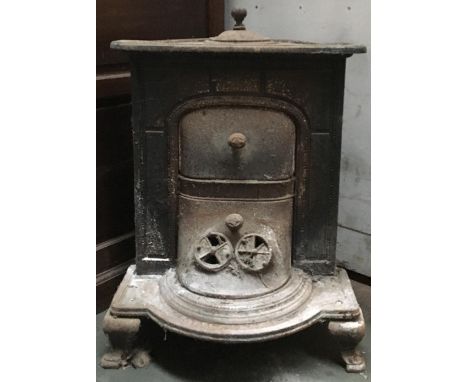 A French cast iron stove with grate and piping, 70cmH 