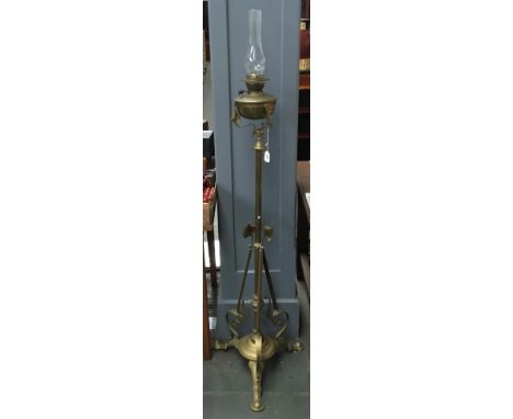 An unusual Art Nouveau standing brass cathedral oil lamp, with glass chimney, adapted for electrical use, 160cm high