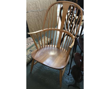 An Ercol beech and elm Chairmakers stickback open armchair