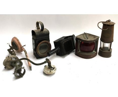 A protector miners lamp, Eccles Manchester; a small ship's port lamp; a carriage lamp with red glass and a  carriage lamp wit