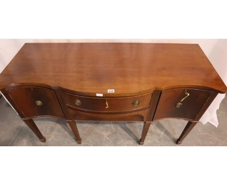 Edwardian mahogany serpentine front sideboard, having top locking cupboards flanking two drawers, raised on tapering supports