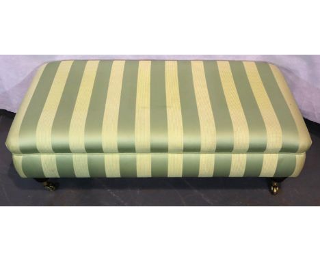 Large contemporary upholstered footstool raised on turned mahogany feet terminating in brass castors, 115 x 60 x 40H cm. Not 