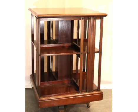 Antique revolving mahogany bookshelves in good condition on ceramic castors 76 x 50 cm. Not available for in-house P&amp;P, c