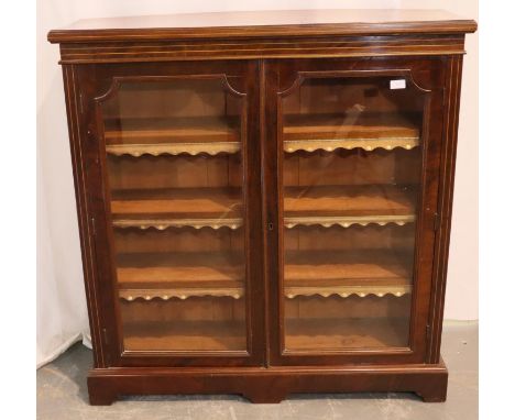 Victorian walnut bookcase with two glazed doors, having three shelves with leather overlays, 106 x 32 x 110H cm. Not availabl