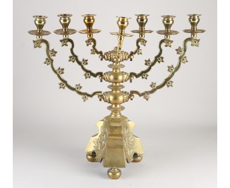 Antique German neo-gothic brass Hanukkah candlestick.&nbsp;seven-armed.&nbsp;With tendrils and fringe decor.&nbsp;Circa 1920.