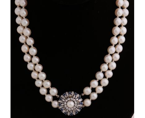Necklace of 2 rows of cultured pearls, ø 8 mm, attached to a large white gold clasp, round model, ø 22 mm, set with a pearl, 