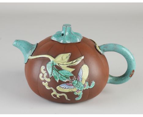 Chinese Yixing teapot with glaze.&nbsp;Floral/butterfly decor.&nbsp;In pumpkin shape.&nbsp;Circa 1900. Dimensions: 11.5 x 18 